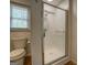 Bathroom featuring a shower with glass doors, wood-look flooring, and a toilet at 6950 Shannon Dr, Lithia Springs, GA 30122