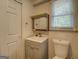 Bathroom with a vanity, a toilet, and a mirror, bathed in natural light at 6950 Shannon Dr, Lithia Springs, GA 30122