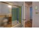 Bathroom with tiled tub and shower, with hall access and storage at 6950 Shannon Dr, Lithia Springs, GA 30122