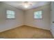 Bedroom with carpet, ceiling fan, and natural light from two windows at 6950 Shannon Dr, Lithia Springs, GA 30122