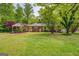 This home boasts a covered carport and lush landscaping, adding to its curb appeal at 6950 Shannon Dr, Lithia Springs, GA 30122