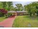 Charming brick home featuring a covered carport and a well-maintained front lawn at 6950 Shannon Dr, Lithia Springs, GA 30122