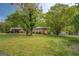Cozy home with mature trees, storage shed, and fenced backyard at 6950 Shannon Dr, Lithia Springs, GA 30122