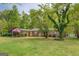 Well-kept home with a convenient covered carport and mature trees at 6950 Shannon Dr, Lithia Springs, GA 30122