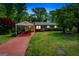 Charming brick home featuring a covered carport and a well-maintained front lawn at 6950 Shannon Dr, Lithia Springs, GA 30122