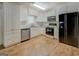 Kitchen showcases white cabinetry, modern appliances, and durable wood-look floors for a stylish, functional space at 6950 Shannon Dr, Lithia Springs, GA 30122