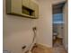 Laundry room with built in cabinetry; a half bath is adjacent at 6950 Shannon Dr, Lithia Springs, GA 30122