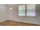 Cozy living area features wood-look flooring, a window and front door at 6950 Shannon Dr, Lithia Springs, GA 30122