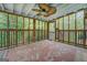 The interior of the screened porch is spacious with an area rug at 6950 Shannon Dr, Lithia Springs, GA 30122