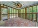 Inside of screened porch with a decorative ceiling fan and area rug at 6950 Shannon Dr, Lithia Springs, GA 30122
