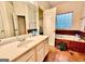 Bathroom with garden tub, double sinks, and large mirror at 144 Garden Walk, Stockbridge, GA 30281