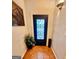 Bright foyer featuring neutral walls, terra-cotta tile flooring, and an ornate, glass-paneled front door at 144 Garden Walk, Stockbridge, GA 30281
