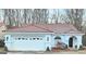 Charming single-story home featuring a red tile roof, arched window, and a two-car garage at 144 Garden Walk, Stockbridge, GA 30281