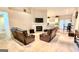 Open concept living room with a fireplace and TV, seamlessly connected to the kitchen at 144 Garden Walk, Stockbridge, GA 30281