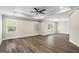 Spacious living room with hardwood flooring, three windows, and a ceiling fan at 634 Gardner Rd, Stockbridge, GA 30281