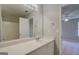 Bathroom featuring a well-lit vanity with a white sink and a view into the attached bedroom at 20 Highgate Trl, Covington, GA 30016