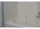 Close-up of the white tiled bathtub and shower combination at 20 Highgate Trl, Covington, GA 30016