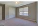 Bedroom with neutral walls, carpet flooring, a window, and a double-door closet at 20 Highgate Trl, Covington, GA 30016