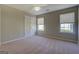 Bedroom with neutral walls, carpet flooring, two windows, and a double-door closet at 20 Highgate Trl, Covington, GA 30016