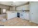 View of a kitchen with tile flooring and white appliances opening into the living room at 20 Highgate Trl, Covington, GA 30016