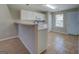 Bright kitchen features white cabinetry, breakfast bar and tile flooring at 20 Highgate Trl, Covington, GA 30016