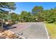 Outdoor basketball court with trees and playground equipment under clear skies, offering recreational amenities at 202 Willow Rock Pt, Fayetteville, GA 30215