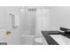 Bathroom with shower-tub combination, white cabinets and black granite countertop at 202 Willow Rock Pt, Fayetteville, GA 30215