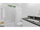 Bathroom with shower-tub combination, black granite countertop and white cabinets at 202 Willow Rock Pt, Fayetteville, GA 30215