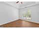 Bedroom with tray ceiling, natural light, and wood-look laminate flooring at 202 Willow Rock Pt, Fayetteville, GA 30215