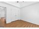 Bedroom with wood-look laminate flooring and closet with double doors at 202 Willow Rock Pt, Fayetteville, GA 30215