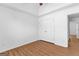 Bedroom with wood-look laminate flooring, overhead fan and closet with double doors at 202 Willow Rock Pt, Fayetteville, GA 30215