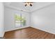 Bedroom with tray ceiling, natural light, and wood-look laminate flooring at 202 Willow Rock Pt, Fayetteville, GA 30215