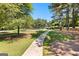 Scenic community path leading to tennis and basketball courts amid lush landscaping and mature trees at 202 Willow Rock Pt, Fayetteville, GA 30215