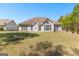 Rear exterior view of house, highlighting windows and green backyard at 202 Willow Rock Pt, Fayetteville, GA 30215