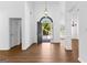 Grand foyer showcases an arched doorway and luxury vinyl floors, blending classic design with modern elegance at 202 Willow Rock Pt, Fayetteville, GA 30215