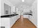 A large kitchen featuring white cabinets, stainless steel appliances and a bar at 202 Willow Rock Pt, Fayetteville, GA 30215