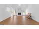 A bright room showcases a fireplace with a white mantel, and a cozy rocking chair atop its modern vinyl plank flooring at 202 Willow Rock Pt, Fayetteville, GA 30215