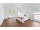 Bright main bedroom offers a tray ceiling, wood floors and large window for natural light at 202 Willow Rock Pt, Fayetteville, GA 30215