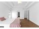 Bright main bedroom with closet, wood floors, large window and tray ceiling at 202 Willow Rock Pt, Fayetteville, GA 30215