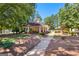 Picnic shelter next to a pool with tables and seating surrounded by lush greenery, providing a recreational space at 202 Willow Rock Pt, Fayetteville, GA 30215