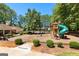 Playground with a slide, swings, picnic shelter surrounded by lush greenery, providing a recreational space at 202 Willow Rock Pt, Fayetteville, GA 30215