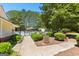 Pool area behind a gate with bushes, providing a refreshing and secure space at 202 Willow Rock Pt, Fayetteville, GA 30215