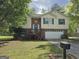 Charming two-story home featuring a brick facade, shuttered windows, and an attached garage at 4379 Cross Ln, Decatur, GA 30035