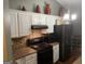 Cozy kitchen featuring modern appliances, granite countertops, white cabinets, and mosaic tile backsplash at 4379 Cross Ln, Decatur, GA 30035