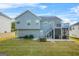 Spacious backyard showcasing a deck, screened in patio, and lush green lawn at 736 Mesa Rd, Mcdonough, GA 30253