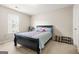 Bright bedroom with a black sleigh bed, colorful accents, and a large window providing natural light at 736 Mesa Rd, Mcdonough, GA 30253