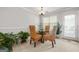 Cozy dining room featuring a round glass table, stylish woven chairs, and a view to the patio at 736 Mesa Rd, Mcdonough, GA 30253