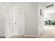 Neutral hallway with closet doors and a glimpse into the adjacent living area at 736 Mesa Rd, Mcdonough, GA 30253