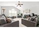 Bright living room featuring a vaulted ceiling, fireplace, and comfortable sofas at 736 Mesa Rd, Mcdonough, GA 30253