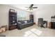 Comfortable living room featuring a couch, desk area with shelving and a large window bringing in natural light at 736 Mesa Rd, Mcdonough, GA 30253